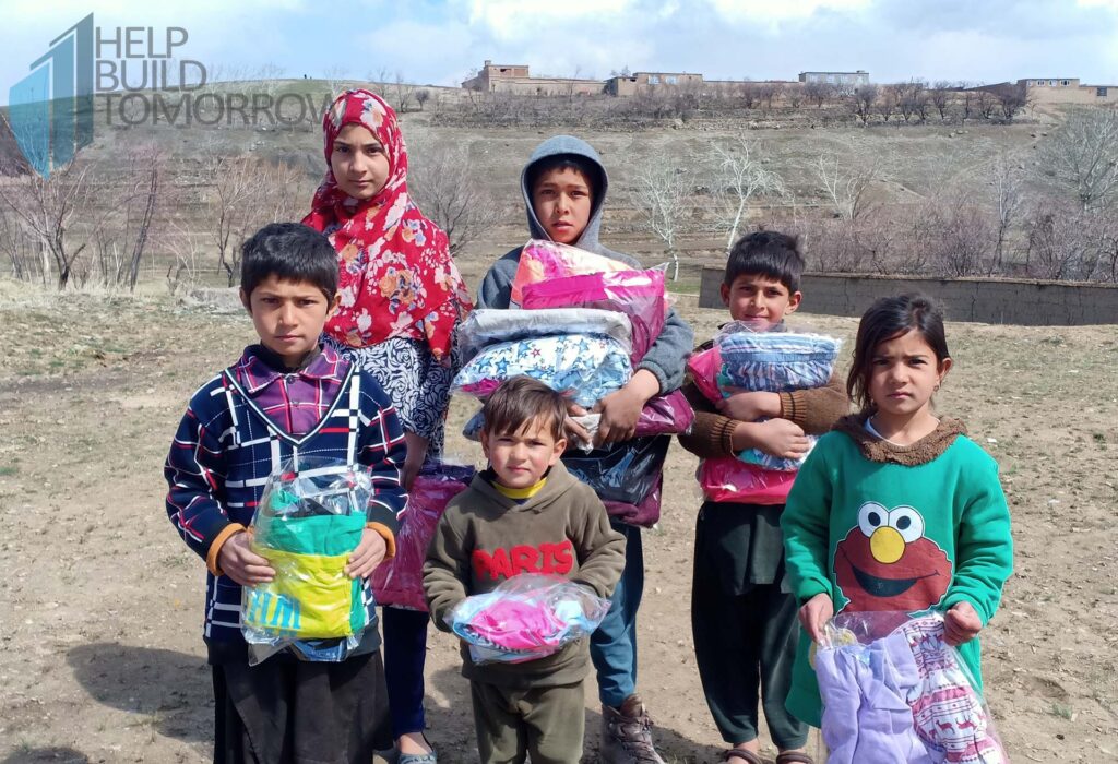 kids receiving worm cloths